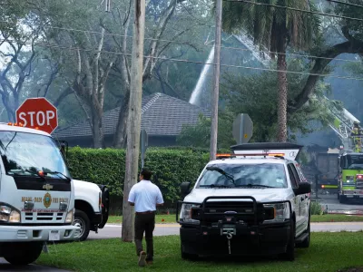 Firefighters work to extinguish the remains of a fire at a home owned by Miami Heat basketball coach Erik Spoelstra, Thursday, Nov. 6, 2025, in Miami. (AP Photo/Rebecca Blackwell)