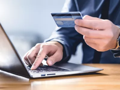 Safe online payment and electronic money transfer security. Pay with digital technology. Man using credit card and laptop to login to internet bank. Financial safety to prevent scam, threat and fraud.