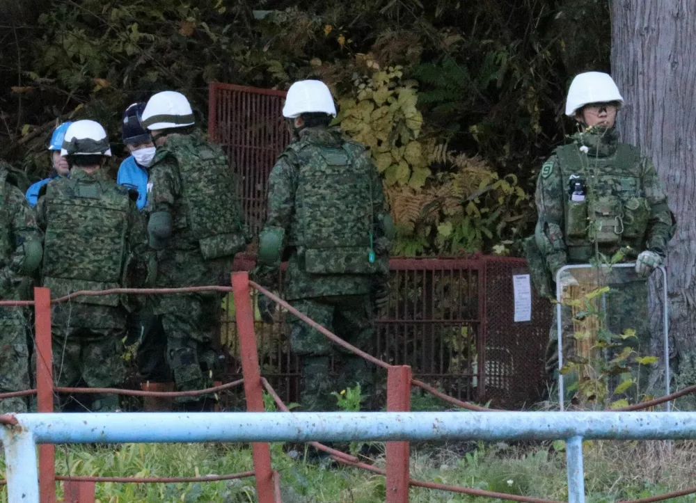 Members of Japan Self-Defense Forces (JSDF) practice setting up a bear trap in Kazuno, Akita Prefecture, Japan, November 5, 2025. REUTERS/Tim Kelly
