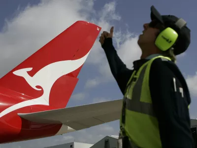 A worker gives his thumb up to a Qantas Airbus A380 as it arrives at a hangar after it landed at Kingsford Smith International Airport in Sydney September 21, 2008. Qantas took delivery of its first A380 superjumbo on Friday, two years later than planned due to production delays, and Airbus denied it planned another cut in its 2008 delivery forecast from the current 12 aircraft.  REUTERS/Daniel Munoz (AUSTRALIA) - RTX8R5U