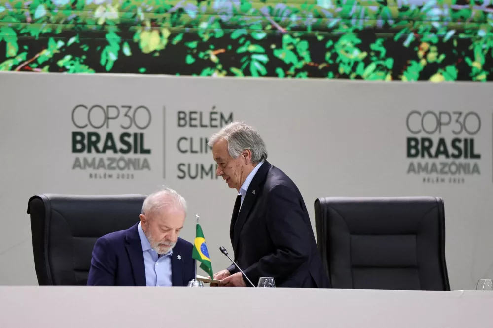 United Nations Secretary-General Antonio Guterres walks next to Brazil's President Luiz Inacio Lula da Silva as they attend the opening of the Belem Climate Summit plenary session, as part of the United Nations Climate Change Conference (COP30), in Belem, Brazil, November 6, 2025. REUTERS/Adriano Machado REFILE - CORRECTING INFORMATION FROM "OPENING OF THE UNITED NATIONS CLIMATE CHANGE CONFERENCE (COP30) TO "THE OPENING OF THE BELEM CLIMATE SUMMIT PLENARY SESSION, AS PART OF THE UNITED NATIONS CLIMATE CHANGE CONFERENCE (COP30)".