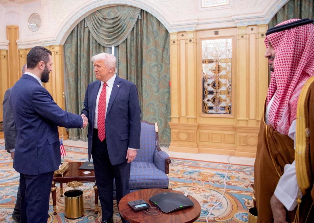 FILE PHOTO: U.S. President Donald Trump meets Syrian President Ahmed al-Sharaa in Riyadh, Saudi Arabia, in this handout released on May 14, 2025. Saudi Press Agency/Handout via REUTERS  THIS IMAGE HAS BEEN SUPPLIED BY A THIRD PARTY/File Photo