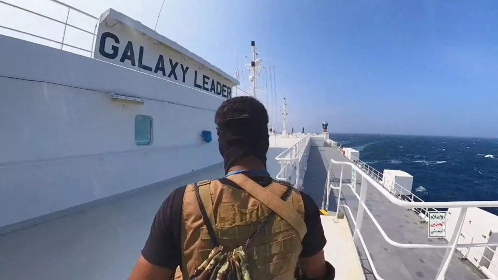 FILE PHOTO: A Houthi fighter stands on the Galaxy Leader cargo ship in the Red Sea in this photo released November 20, 2023. Houthi Military Media/Handout via REUTERS  THIS IMAGE HAS BEEN SUPPLIED BY A THIRD PARTY/File Photo
