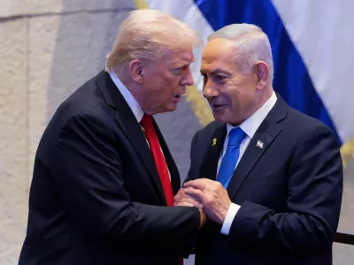 FILE - President Donald Trump talks with Israel's Prime Minister Benjamin Netanyahu at the Knesset, Israel's parliament, Monday, Oct. 13, 2025, in Jerusalem. (Chip Somodevilla/Pool via AP, file)