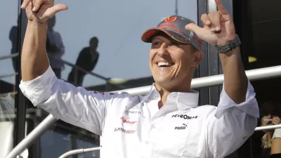 FILE - In this Sept. 1, 2012 file photo Mercedes Grand Prix driver Michael Schumacher of Germany celebrates in the paddock after the qualifying session ahead the Belgium Formula One Grand Prix in Spa-Francorchamps circuit, Belgium. Schumacher, is poised to compete in his 300th GP on Sunday at the age of 43. Seven-time world champion Michael Schumacher confirmed Thursday Oct. 4, 2012 that he will retire for good at the end of current Formula One season. (AP Photo/Luca Bruno, File) / Foto: Luca Bruno