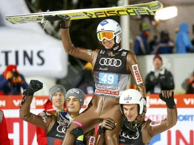 Ski Jumping - 65th four-hills ski jumping tournament final round - Bischofshofen, Austria - 06/01/2017 - Poland's Kamil Stoch celebrates among his compatriots after winning the 65th four-hills tournament.  REUTERS/Dominic Ebenbichler