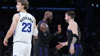 Nov 18, 2025; Los Angeles, California, USA; Los Angeles Lakers forward LeBron James (center) and guard Luka Doncic (77) react as Utah Jazz forward Lauri Markkanen (23) watches in the fourth quarter at Crypto.com Arena. Mandatory Credit: Kirby Lee-Imagn Images