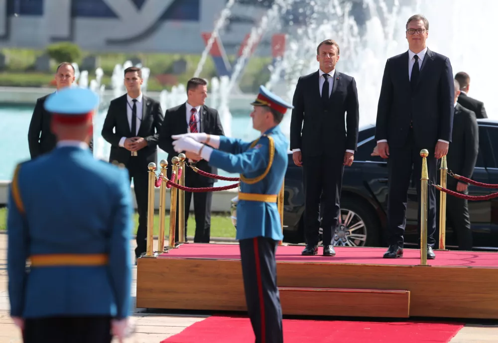 Serbian President Aleksandar Vucic and French President Emmanuel Macron inspect an honour guard outside the Serbia Palace building in Belgrade, Serbia, July 15, 2019. REUTERS/Djordje Kojadinovic