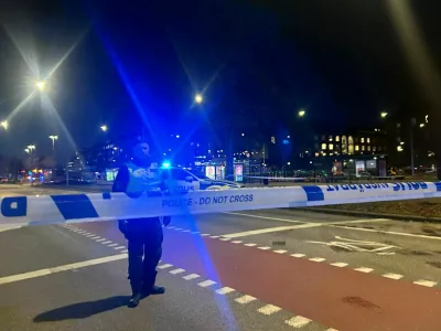 A Swedish police officer stands near the site where a bus hit a bus stop in central Stockholm, Sweden, November 14, 2025. REUTERS/Marie Mannes