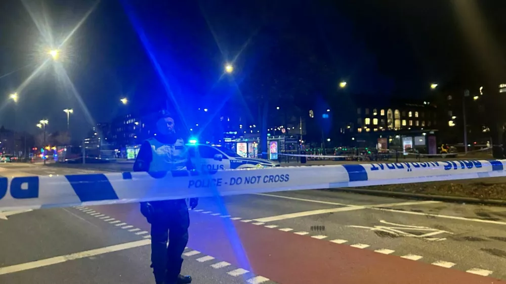 A Swedish police officer stands near the site where a bus hit a bus stop in central Stockholm, Sweden, November 14, 2025. REUTERS/Marie Mannes