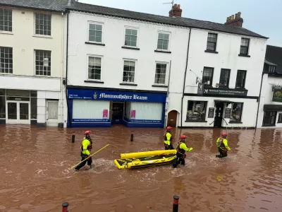 Rescue workers wade through floodwater after severe flooding in south Wales, as Storm Claudia reaches parts of the United Kingdom, in Monmouth, Wales, Britain, November 15, 2025 in this picture obtained from social media. Kim Kaos/via REUTERS THIS IMAGE HAS BEEN SUPPLIED BY A THIRD PARTY. MANDATORY CREDIT. NO RESALES. NO ARCHIVES.  VERIFICATION: Reuters was able to verify the location from the design of the buildings, position of the road and shop signs which matched file and satellite imagery of the area. That was confirmed from the original file metadata.