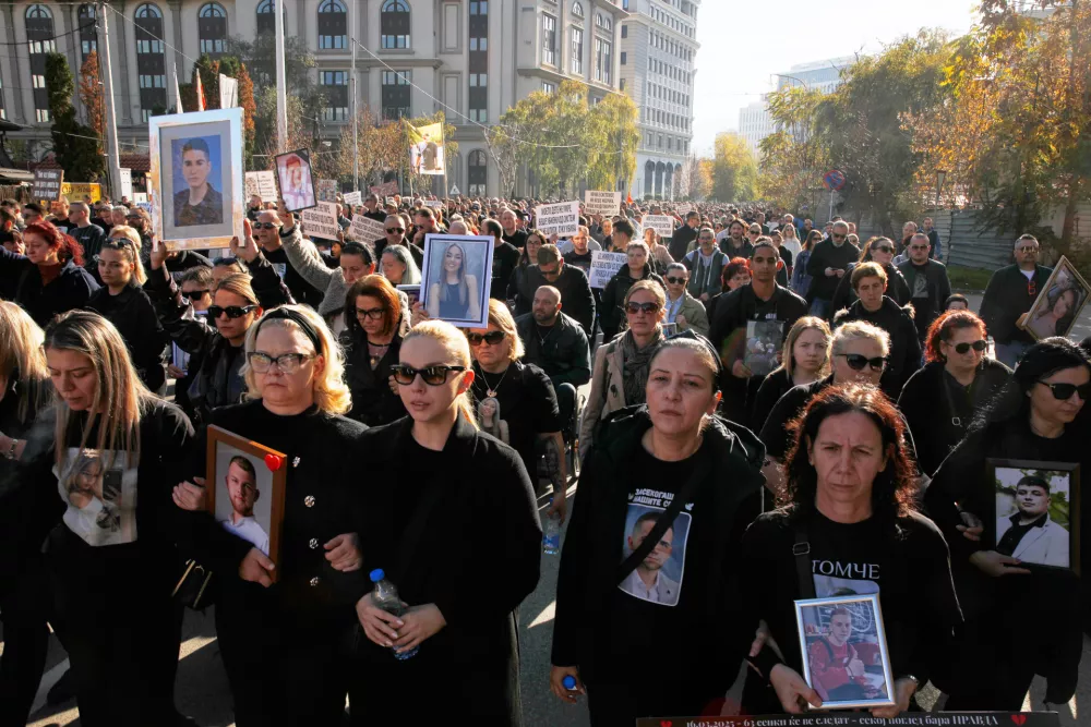 Relatives protest carrying pictures of the Kocani nightclub fire victims, a fire that killed 63 people, while marching in Skopje, North Macedonia, on Saturday, Nov. 15, 2025, just a few days before the start of the trial for the fire. (AP Photo/Boris Grdanoski)