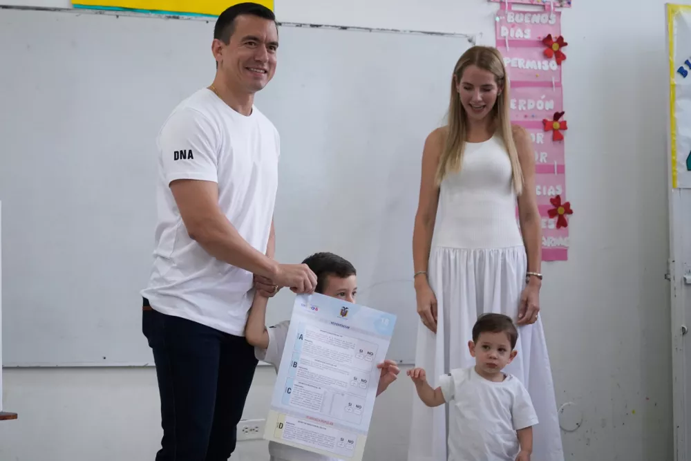 Ecuadorian President Daniel Noboa, accompanied by his family, votes in a referendum on whether to allow foreign military bases in the country and rewrite the constitution through a constituent assembly, in Olon, Ecuador, Sunday, Nov. 16, 2025. (AP Photo/Cesar Munoz)