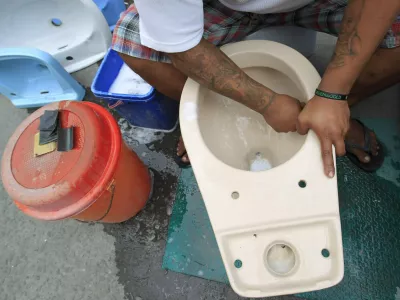 A worker cleans a recycled toilet bowl before putting for sale at 1,500 pesos () each along a major street in Manila November 19, 2014. The United Nations General Assembly has declared November 19 as World Toilet Day to raise awareness about the need for all human beings to have access to sanitation. REUTERS/Romeo Ranoco (PHILIPPINES - Tags: SOCIETY)