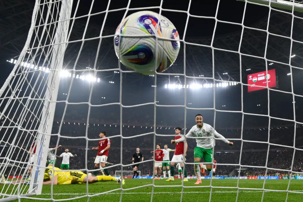 Hungary goalkeeper Denes Dibusz fails to save a shot by Ireland's Troy Parrott who scored his side's third goal during the World Cup 2026 group F qualifying soccer match between Hungary and Ireland in Budapest, Hungary, Sunday, Nov. 16, 2025. (AP Photo/Denes Erdos)