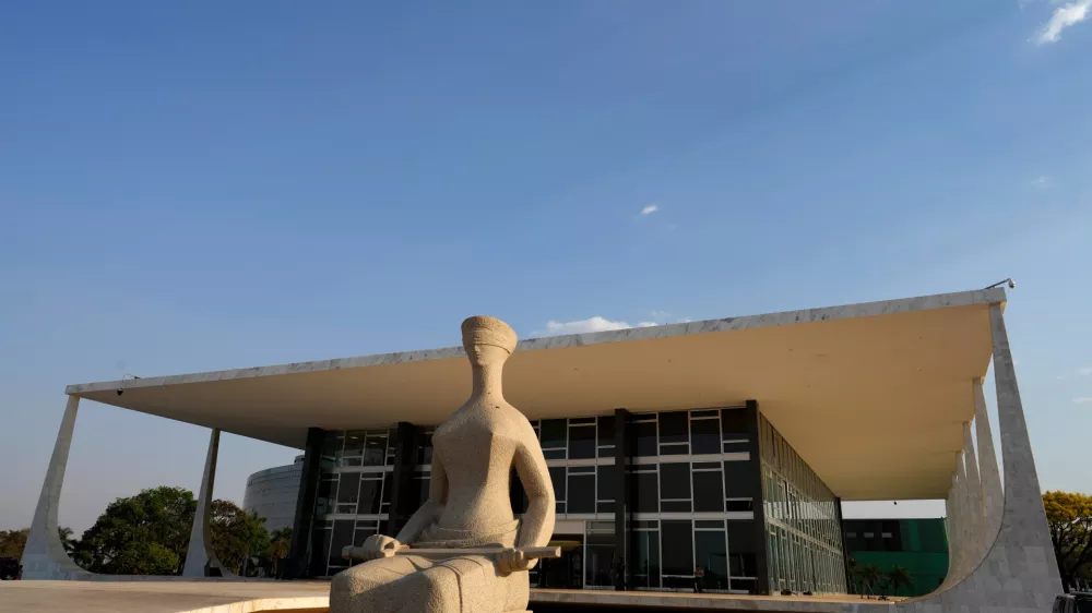 FILE - The Statue of Justice stands in front of the Supreme Court during the verdict and sentencing phase of a trial for those charged in an alleged coup plot to keep Brazil's former President Jair Bolsonaro in office after his 2022 election defeat, in Brasilia, Brazil, Sept. 11, 2025. (AP Photo/Eraldo Peres, File)