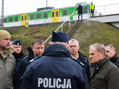 Prime Minister Donald Tusk, second right, visits site of the rail line Mika, that was damaged by sabotage, near Deblin, Poland, Monday, Nov. 17, 2025. (AP Photo/KPRM)