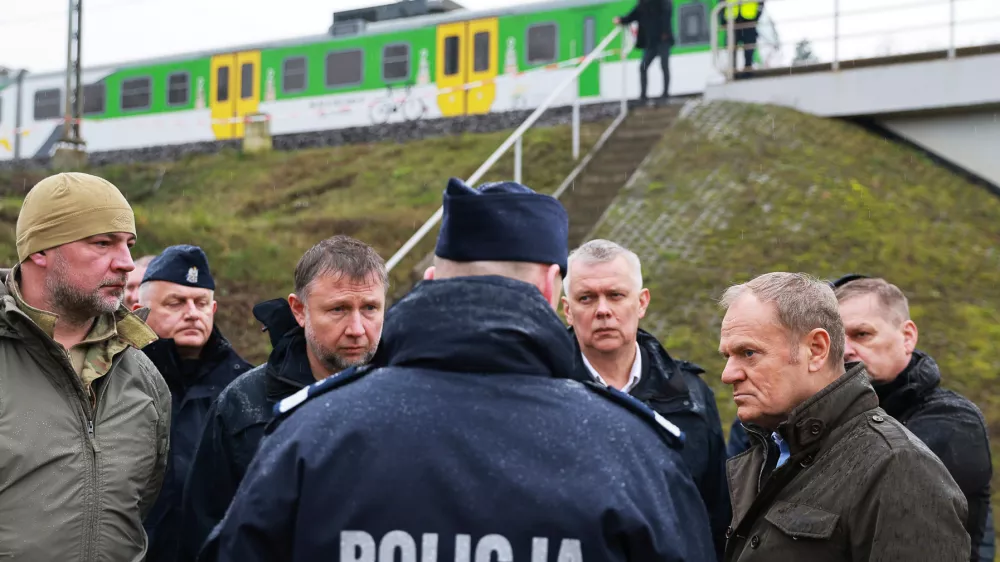 Prime Minister Donald Tusk, second right, visits site of the rail line Mika, that was damaged by sabotage, near Deblin, Poland, Monday, Nov. 17, 2025. (AP Photo/KPRM)