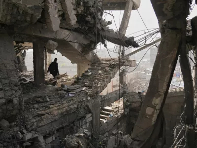 Palestinians inspect the ruins a day after an Israeli strike on a building in Gaza City, Thursday, Nov. 20, 2025. (AP Photo/Jehad Alshrafi)