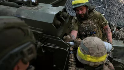 Service members of the 15th 'Kara-Dag' Brigade of the Operational Assignment of the National Guard of Ukraine load ammunition into a 2A36 Giatsint-B howitzer as they fire it towards Russian troops, at a position on a front line near the town of Kupiansk, amid Russia's attack on Ukraine, in Kharkiv region, Ukraine May 27, 2025. REUTERS/Anatolii Stepanov