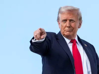 FILE PHOTO: U.S. President Donald Trump gestures, while he boards Air Force One, as he departs for New York at Joint Base Andrews, Maryland, U.S., September 11, 2025. REUTERS/Ken Cedeno/File Photo
