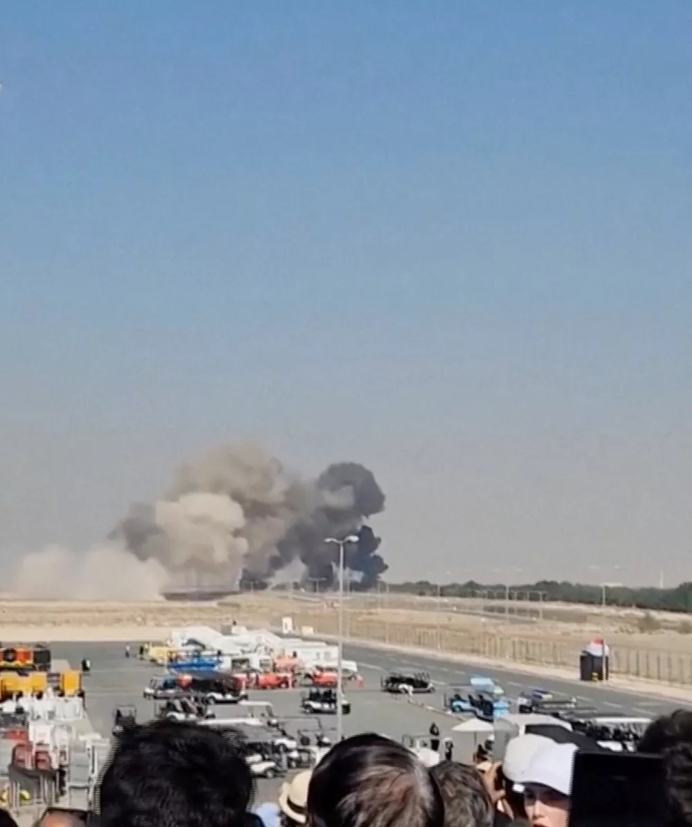 Smoke billows following a crash of Indian home-produced Tejas fighter jet, after it lost altitude and crashed during an aerial display at the Dubai Air Show, in Dubai, United Arab Emirates, November 21, 2025, in this screengrab obtained from an eyewitness video. JIGNESH VARIYA via REUTERS THIS IMAGE HAS BEEN SUPPLIED BY A THIRD PARTY. MANDATORY CREDIT. NO RESALES. NO ARCHIVES. Verification: -Location confirmed by the road layout and trees that matched file, and satellite images of the area -Date verified by original files metadata