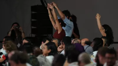 Delegates from Colombia react during a plenary session at the COP30 U.N. Climate Summit, Saturday, Nov. 22, 2025, in Belem, Brazil. (AP Photo/Andre Penner)
