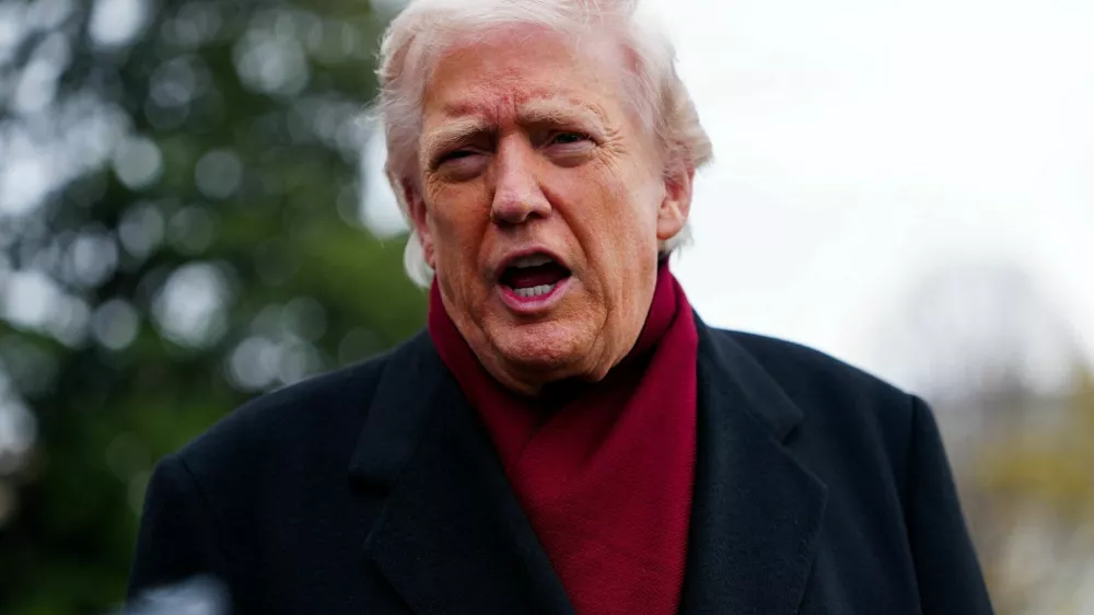 U.S. President Donald Trump speaks to the media while on his way to board Marine One to depart for Joint Base Andrews, from the South Lawn at the White House in Washington, D.C., U.S., November 22, 2025. REUTERS/Aaron Schwartz
