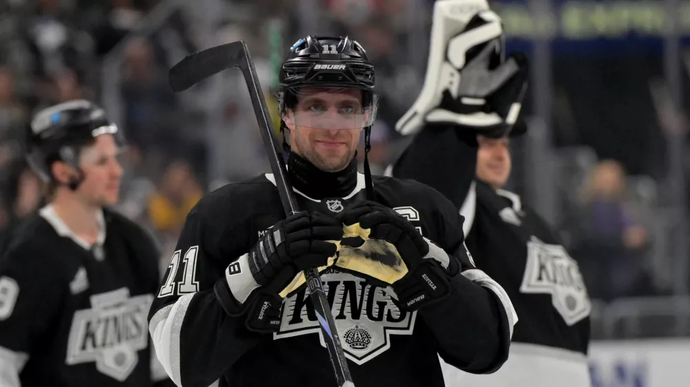 Apr 23, 2025; Los Angeles, California, USA; Los Angeles Kings center Anze Kopitar (11) makes a heart with his gloves for he daughter after defeating the Edmonton Oilers in game 2 of the 2025 Stanley Cup Playoffs at Crypto.com Arena. Mandatory Credit: Jayne Kamin-Oncea-Imagn Images