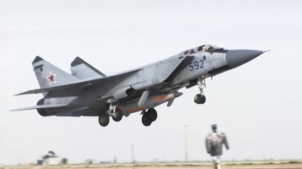 In this video grab provided by RU-RTR Russian television via AP television on Thursday, March 1, 2018, a Russian MiG-31 fighter jet carrying the new Kinzhal hypersonic missile flies at an undisclosed location in Russia. President Vladimir Putin declared Thursday that Russia has developed a range of new nuclear weapons, claiming they can't be intercepted by enemy. (RU-RTR Russian Television via AP)