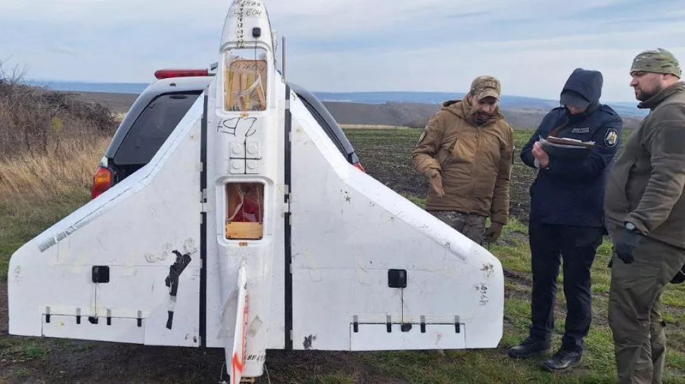 This image released by Moldova's Police on Tuesday, Nov. 25, 2025, police officers inspect a drone in the village of Cuhurestii de Jos, northern Moldova. (Moldova Police via AP)