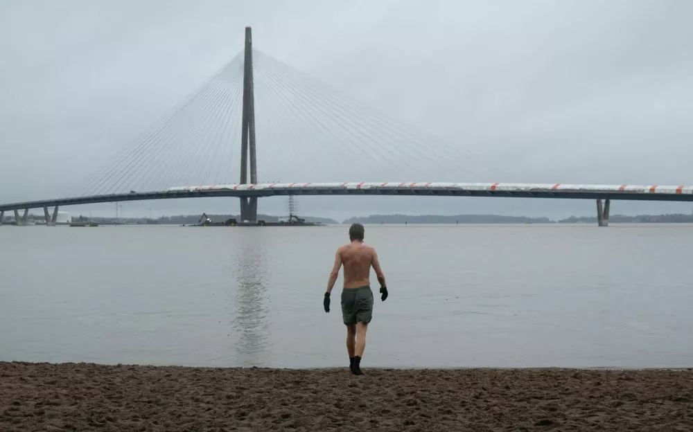 Juho-Pekka Palomaa walks into the sea to swim after using a sauna in Helsinki, Finland, October 31, 2025. REUTERS/Tom Little