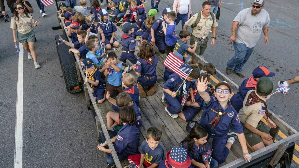 Scouting America participants from Anderson wave on a trailer during The Anderson County Veterans Parade held Sunday, November 9, in downtown Anderson, S.C.