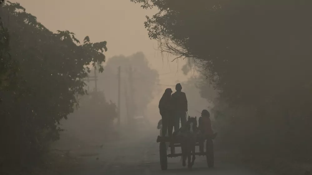 Indian ride horse cart on a cold and foggy morning near the India-Pakistan international border area of Ranbir Singh Pura, about 35 kilometers (22 miles) south of Jammu, India, Monday, Nov. 24, 2025.(AP Photo/Channi Anand)