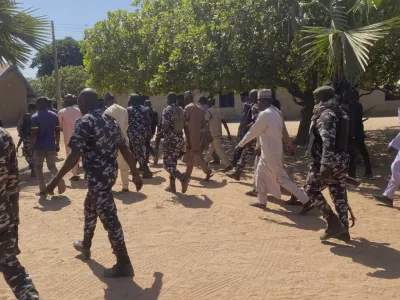Police and government officials walk past St. Mary's Catholic Primary and Secondary School where gunmen on Friday abducted children and staff in Papiri community, Nigeria, Tuesday, Nov.25, 2025. (AP Photo/Yunusa Umar)