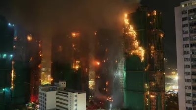 Firefighters work to extinguish flames, as fire burns bamboo scaffolding across multiple buildings at Wang Fuk Court housing estate, in Tai Po, Hong Kong, China, November 26, 2025. REUTERS/Tyrone Siu