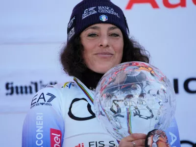 FILE - Italy's Federica Brignone smiles on the podium after winning the women's World Cup overall at the World Cup Finals, March 27, 2025, in Sun Valley, Idaho. (AP Photo/John Locher, File)