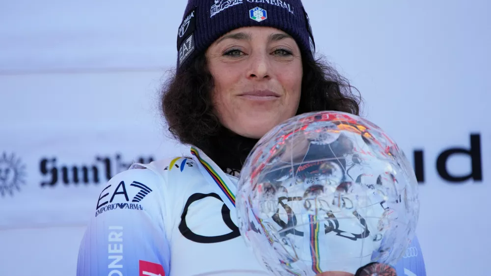 FILE - Italy's Federica Brignone smiles on the podium after winning the women's World Cup overall at the World Cup Finals, March 27, 2025, in Sun Valley, Idaho. (AP Photo/John Locher, File)