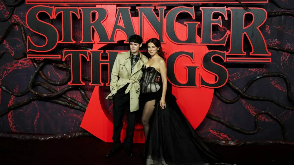 FILE PHOTO: Cast members Noah Schnapp and Millie Bobby Brown attend the screening for the final season of the television series "Stranger Things", at Odeon Luxe Leicester Square in London, Britain, November 13, 2025. REUTERS/Isabel Infantes/File Photo