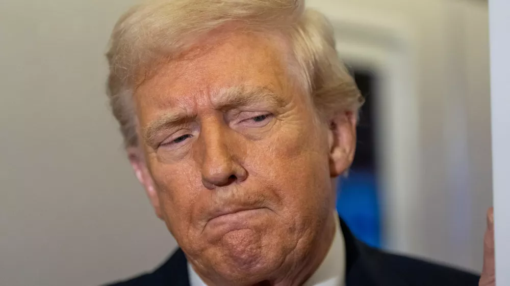 President Donald Trump pauses while speaking with reporters while in flight on Air Force One from Joint Base Andrews to his Mar-a-Lago estate in Palm Beach, Fla., Tuesday, Nov. 25, 2025. (AP Photo/Alex Brandon)