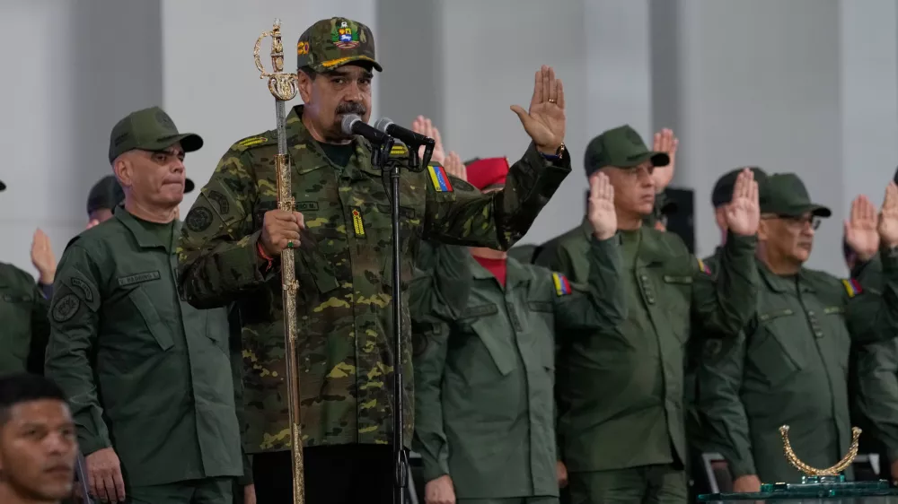 Venezuelan President Nicolas Maduro administers an oath during a civic-military event at the military academy in Caracas, Venezuela, Tuesday, Nov. 25, 2025. (AP Photo/Ariana Cubillos)