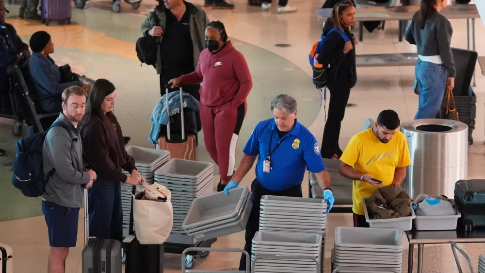Travelers make their way through security at Love Field Airport, Wednesday, Nov. 26, 2025, in Dallas. (AP Photo/LM Otero)