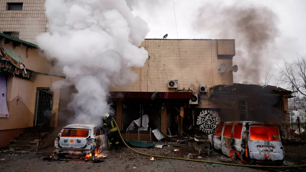 A firefighter extinguishes a fire in a car damaged during a Russian missile and drone attack on Kyiv, amid Russia's attack on Ukraine, November 29, 2025. REUTERS/Valentyn Ogirenko