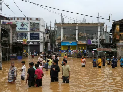 People gather at an area affected by floods, following heavy rainfall in Malwana, Sri Lanka, November 29, 2025. REUTERS/ Thilina Kaluthotage