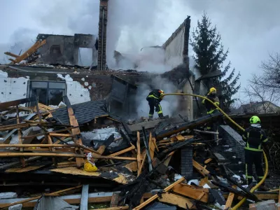 Firefighters work at the site of a private home that went up in flames after it was hit by a Russian drone during a night of attacks on Kyiv, amid Russia's attack on Ukraine, November 29, 2025. REUTERS/Thomas Peter    TPX IMAGES OF THE DAY