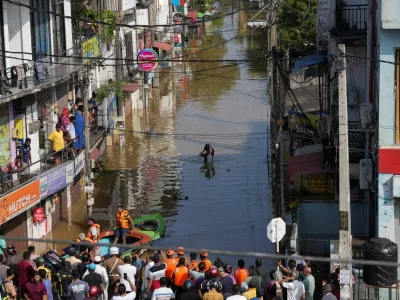 A man wades through the flooded street, following heavy rainfall in Wellampitiya, Sri Lanka, November 30, 2025. REUTERS/Thilina Kaluthotage