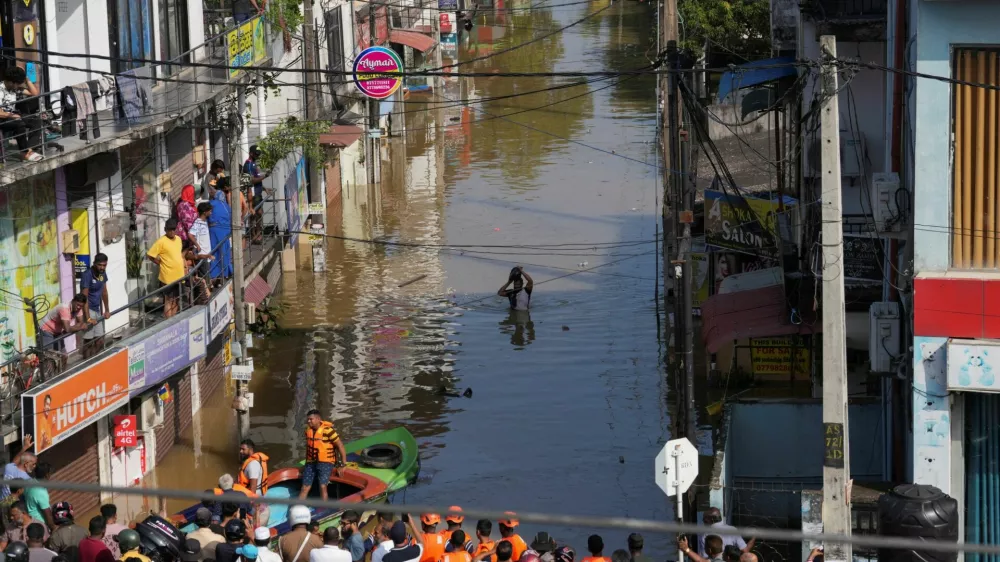 A man wades through the flooded street, following heavy rainfall in Wellampitiya, Sri Lanka, November 30, 2025. REUTERS/Thilina Kaluthotage