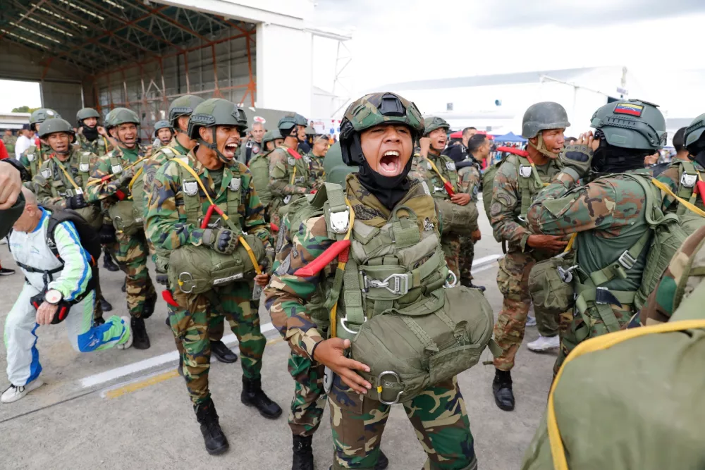 Skydivers get revved to perform in the Industrial Aviation Expo at the Libertador Air Base in Maracay, Venezuela, Saturday, Nov. 29, 2025. (AP Photo/Cristian Hernandez)