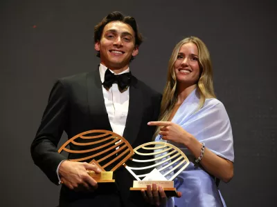 Athletics - 2025 World Athletics Awards - Monaco - November 30, 2025 Male Field Athlete and World Athlete of the Year winner Armand Duplantis poses with his partner Desire Inglander and the awards REUTERS/Manon Cruz
