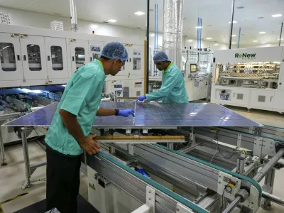Workers check a solar panel at a ReNew manufacturing plant on the outskirts of Jaipur, India, Thursday, Aug. 21, 2025. (AP Photo/Manish Swarup)